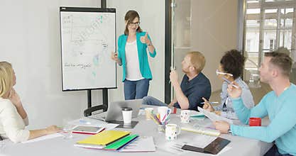 Woman showing graphics for coworkers