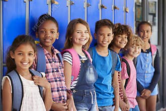 School kids in front of lockers in elementary school hallway