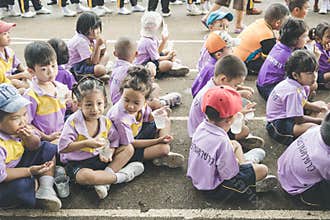 Trang, Thailand - June 23, 2017: Kindergarten children waiting for enjoy activity on sports day at public ground in Trang Thailand