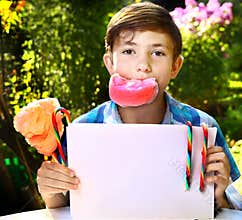 boy with cotton candy and sheet of paper