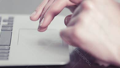 Woman's hands using a trackpad on a portable computer