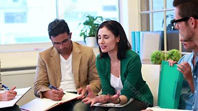 Casual business team speaking together during meeting