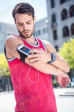 Handsome athlete adjusting his armband