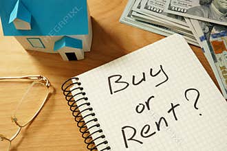 Real estate concept. Notepad with buy or rent Ñ„Ñ‚Ð²home model.