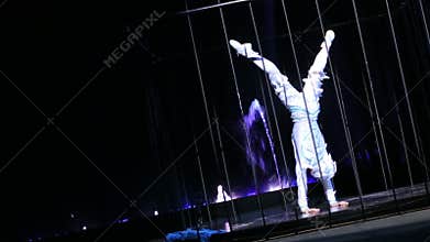 Acrobatic dancing performance in the cage