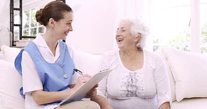 Senior woman talking with nurse
