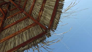 Palapa or bungalow straw shed over blue sky