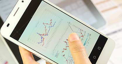 4k Business people browsing finance pie charts & stock trend on smartPhone.