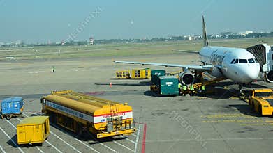 Vietnamese people loading baggage to store room of plane