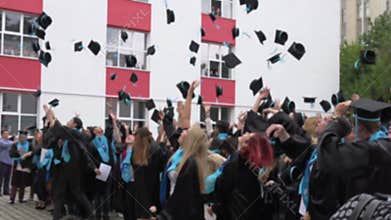 BUCHAREST,ROMANIA,MAY 2016.Blurred image of students throwing hats in the air,graduating High School Benjamin Franklin.