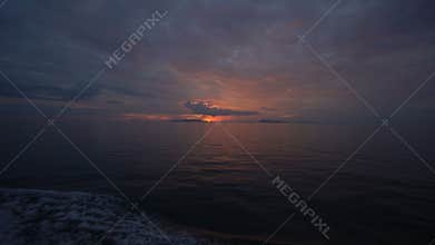 Beautiful sunset on waving sea, view from top deck of moving boat cruiser