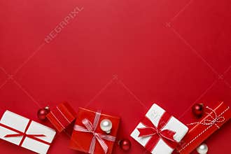 Simple, modern red & white Christmas gifts presents on red background. Festive holiday border.
