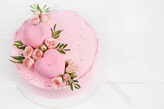 Pink cake. Hearts on the top of cake decorated of pink roses. Concept for Wedding , St. Valentine`s Day, Mother`s Day, Birthday