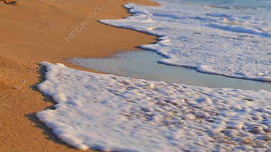 Sunrise sea. Ocean waves splash on the beach coastline.
