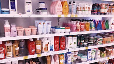 Shelves with cosmetics and beauty products in a drug store, customer service and shopping