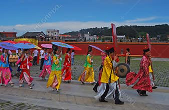 A group of female with colourful traditional umbrellas attending anniversary ceremony in Tong An District, Xiamen, Fujian, China