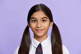 Smiling indian kid girl wear school uniform stand on lilac background, portrait.