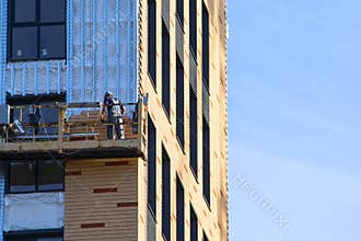 Apartment building. High-altitude works and industrial alpinism background.