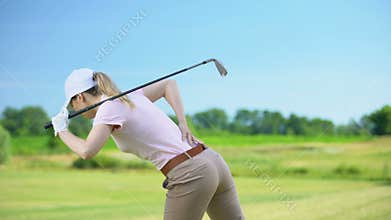 Female with club playing golf, suffering pain in back, sports trauma and health