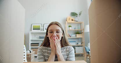 Slow motion of surprised girl opening box looking inside expressing happiness