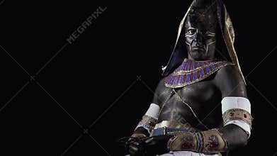 The ancient egyptian god Anubis, a man with makeup and clothes as Anubis