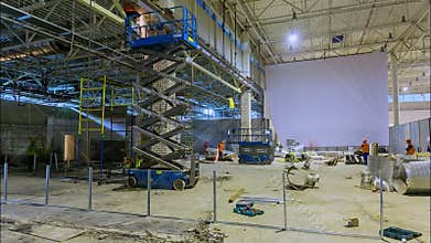 Builders work in light room at mall construction timelapse