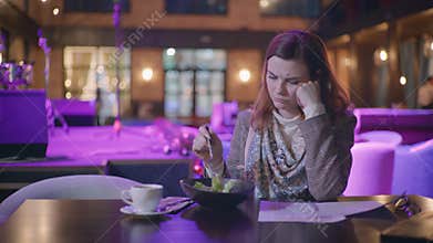 Diet food, sad girl lover of eat monitors her weight adheres to dietary nutrition eating is vegetarian salad of fresh