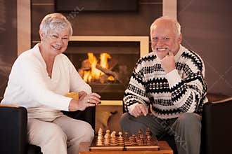 Portrait of elderly couple playing chess