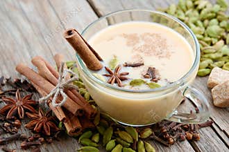 Cup of healthy masala tea with milk and aromatic spices and herbs. Ayurveda treatments.
