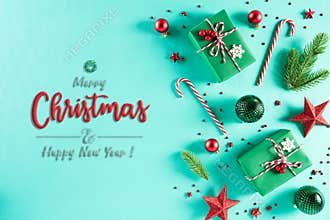 Christmas background concept. Top view of Christmas green gift box with candy cane decoration, spruce branches, star, red berries