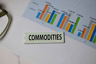 Commodities write on sticky note isolated on Office Desk