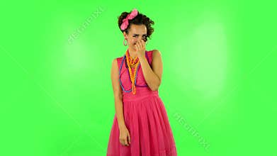 Woman coquettishly smiling while looking at camera. Green screen