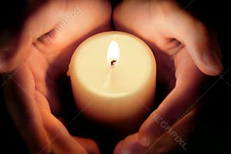 Candle between the hands