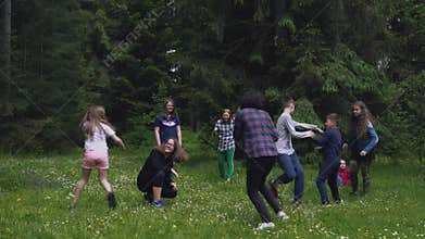 Teens having fun, running in forest.