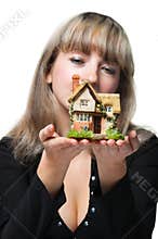 The business woman holds the small house