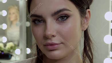 Beautiful face woman with classic make-up posing in front of the camera.