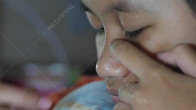 Close up of young teenage girl squeezing acne on her nose