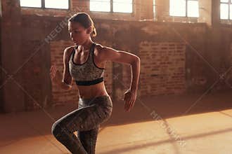 Fitness workout. Woman running on spot, doing cardio exercise