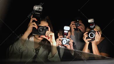 Celebrity looking from car at newspaper paparazzi making shoots, point of view