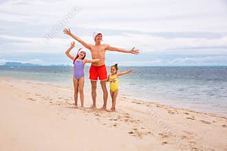 Young friendly family father and two dauthers are happy in summer Christmas on beach