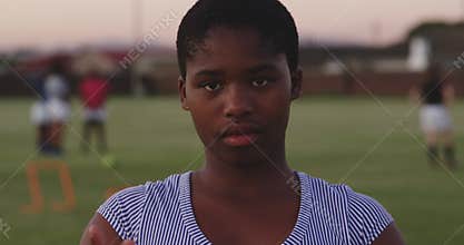 Portrait of young adult female rugby player on a rugby pitch