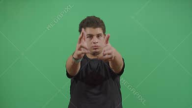 Aggressive young boy shooting the viewer