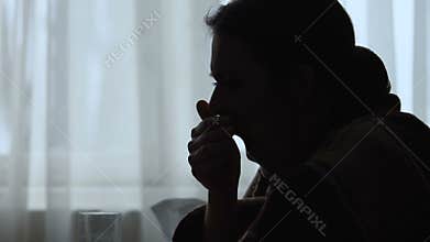 Silhouette girl yawning, suffering insomnia until morning, stress disturbs sleep