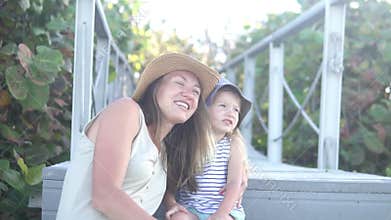 Cute mom and daughter on a walk in the park in the summer