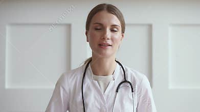 Young woman doctor talk by video chat consult patient online