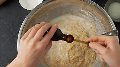 Hands making batter with milk at bakery