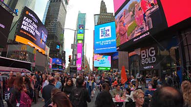 New York, NY, USA. Crowded Time Square and billboards on buildings facades at late afternoon or early evening