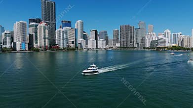 Areal view of white luxurious sailboats moving fast along oceanfront of Brickell. Increadible seascape with modern multi