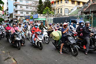 Motorbike riders at rush hour in the streets of Ho Chi Minh City, formerly Saigon, Vietnam