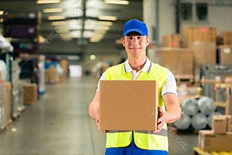 Worker holds package in warehouse of forwarding